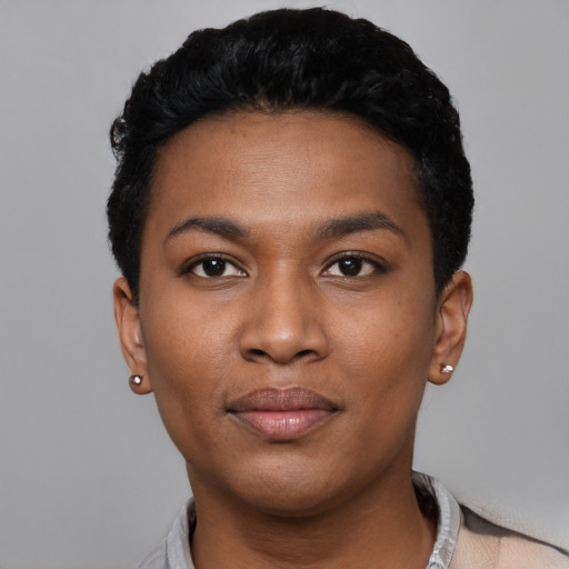 Joyful black young-adult female with short  black hair and brown eyes