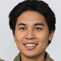 Joyful asian young-adult male with short  black hair and brown eyes