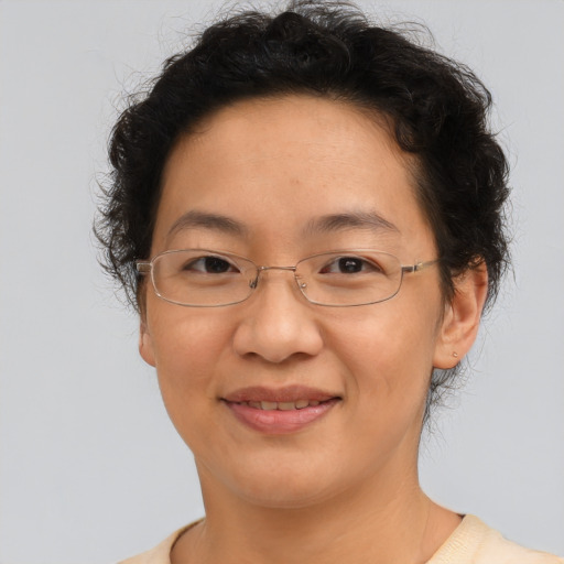 Joyful asian adult female with short  brown hair and brown eyes