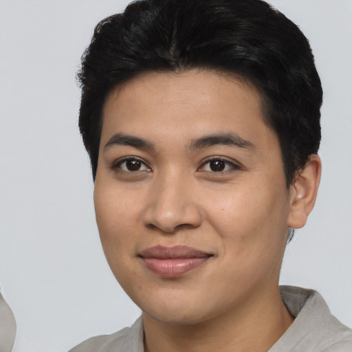 Joyful asian young-adult female with short  brown hair and brown eyes