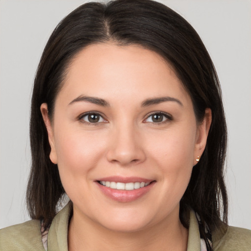 Joyful white young-adult female with medium  brown hair and brown eyes