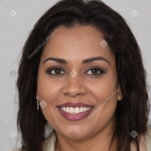 Joyful black young-adult female with long  brown hair and brown eyes