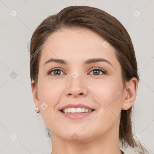 Joyful white young-adult female with medium  brown hair and grey eyes