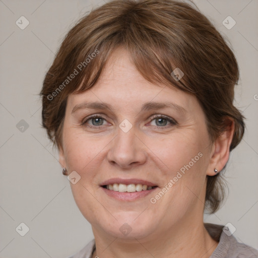 Joyful white adult female with medium  brown hair and grey eyes