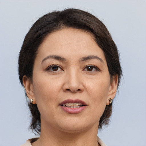 Joyful white adult female with medium  brown hair and brown eyes