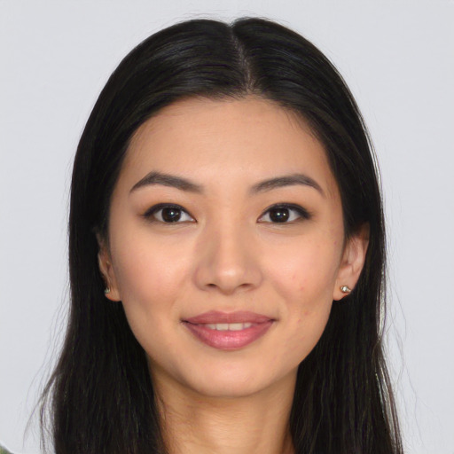 Joyful asian young-adult female with long  brown hair and brown eyes