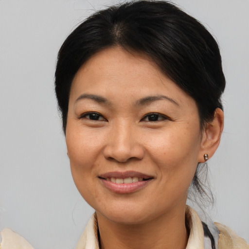 Joyful asian young-adult female with medium  brown hair and brown eyes