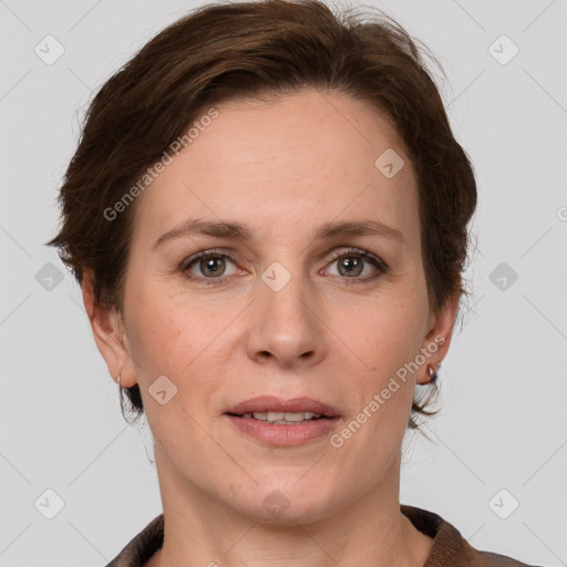 Joyful white adult female with medium  brown hair and grey eyes