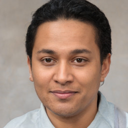 Joyful latino young-adult male with short  brown hair and brown eyes