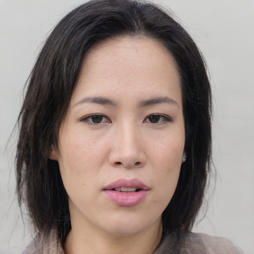 Neutral asian young-adult female with medium  brown hair and brown eyes