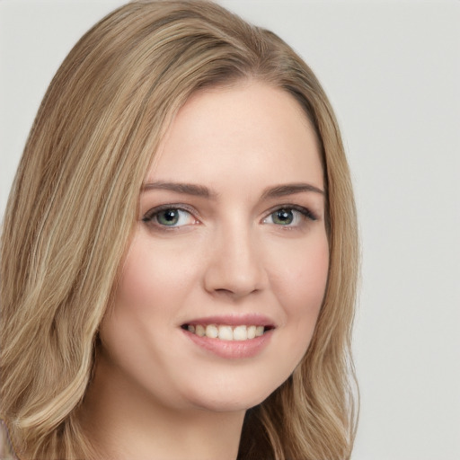 Joyful white young-adult female with long  brown hair and green eyes