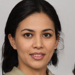 Joyful latino young-adult female with medium  brown hair and brown eyes