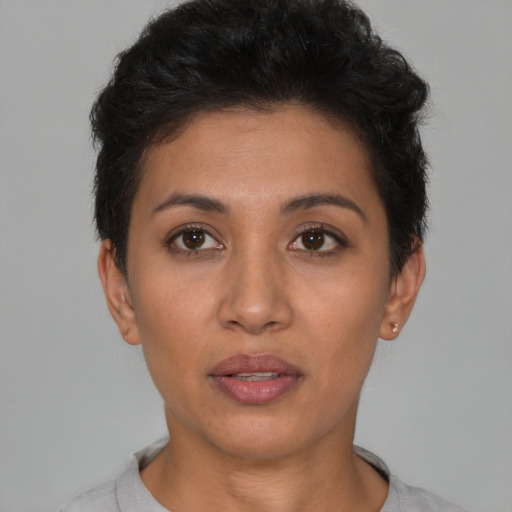 Joyful latino young-adult female with short  brown hair and brown eyes