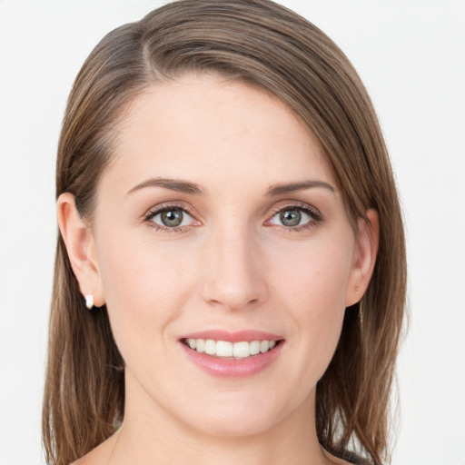 Joyful white young-adult female with medium  brown hair and grey eyes