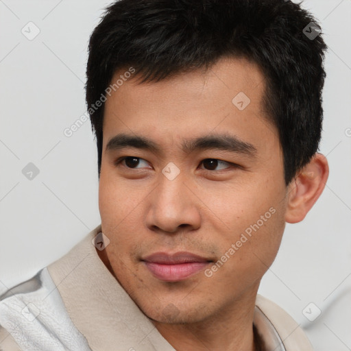 Joyful asian young-adult male with short  black hair and brown eyes