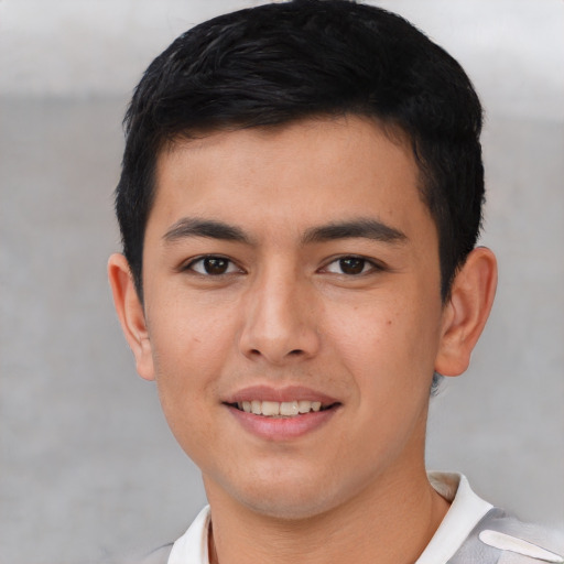 Joyful asian young-adult male with short  black hair and brown eyes