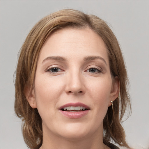 Joyful white young-adult female with medium  brown hair and grey eyes