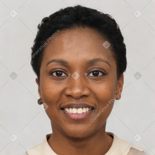 Joyful black young-adult female with short  black hair and brown eyes