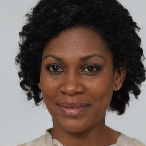 Joyful black adult female with medium  black hair and brown eyes