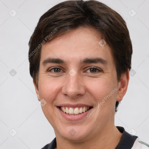 Joyful white young-adult male with short  brown hair and grey eyes