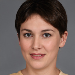 Joyful white young-adult female with short  brown hair and brown eyes