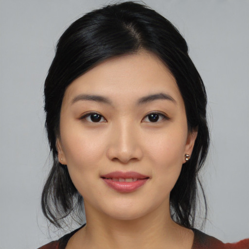 Joyful asian young-adult female with medium  black hair and brown eyes