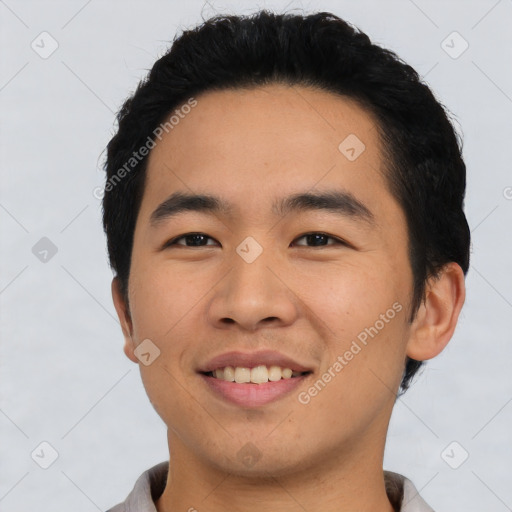 Joyful asian young-adult male with short  black hair and brown eyes