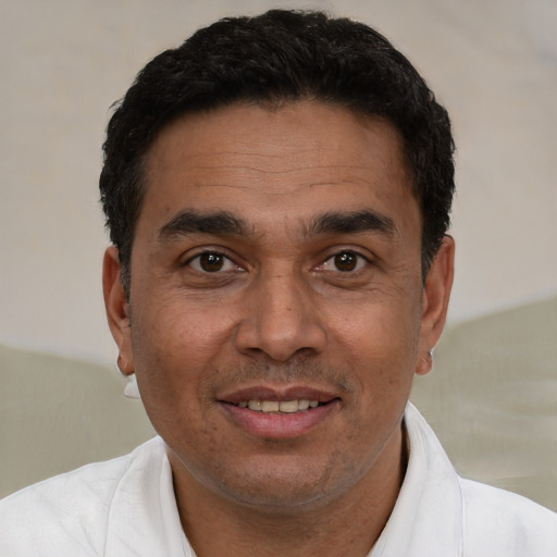 Joyful white adult male with short  black hair and brown eyes