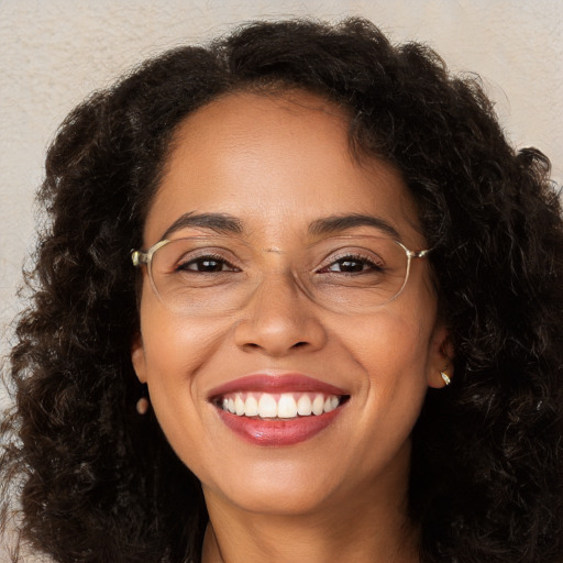 Joyful white adult female with long  brown hair and brown eyes