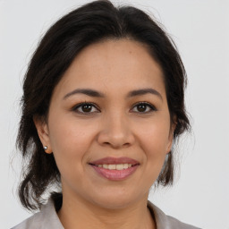 Joyful latino young-adult female with medium  brown hair and brown eyes