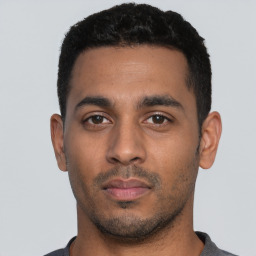 Neutral latino young-adult male with short  black hair and brown eyes