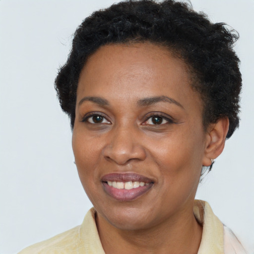 Joyful black adult female with short  brown hair and brown eyes