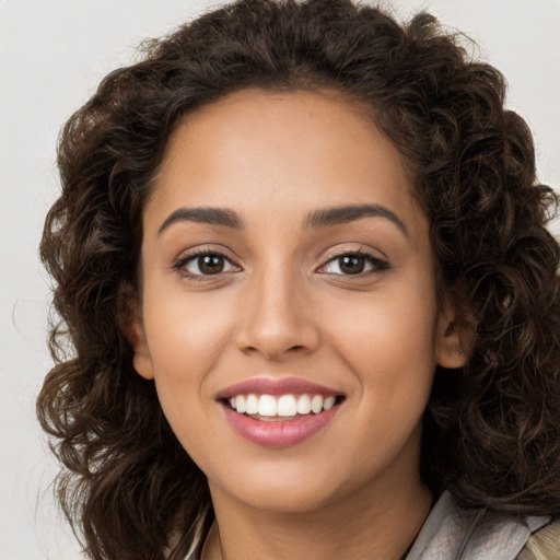 Joyful white young-adult female with long  brown hair and brown eyes