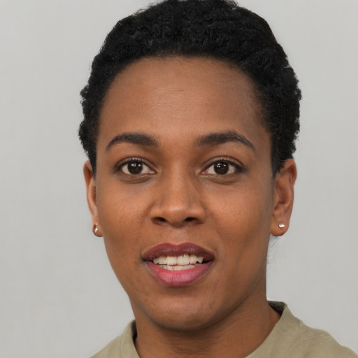 Joyful black young-adult female with short  black hair and brown eyes