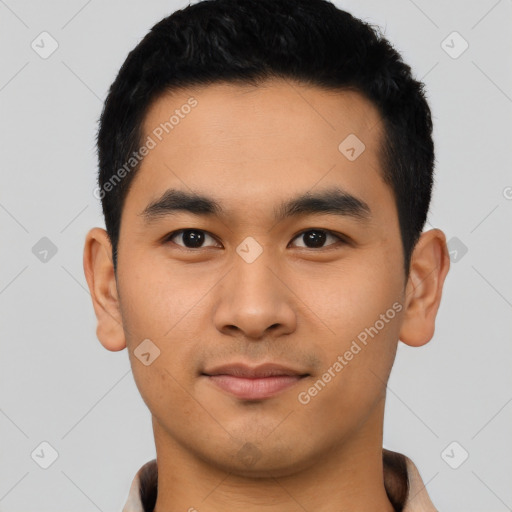 Joyful asian young-adult male with short  black hair and brown eyes