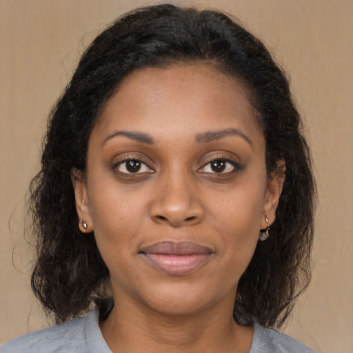 Joyful black young-adult female with medium  brown hair and brown eyes