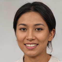 Joyful asian young-adult female with medium  brown hair and brown eyes