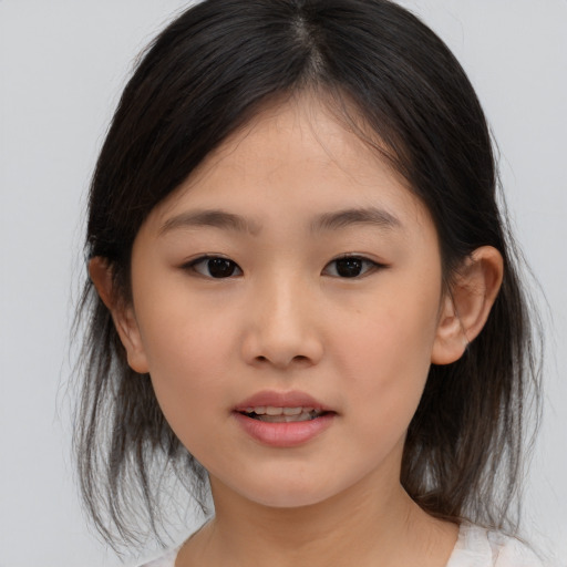 Joyful asian child female with medium  brown hair and brown eyes