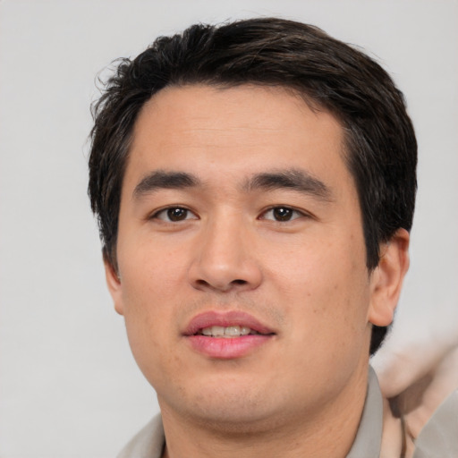 Joyful white young-adult male with short  black hair and brown eyes