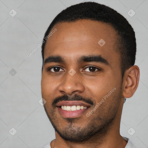 Joyful black young-adult male with short  black hair and brown eyes