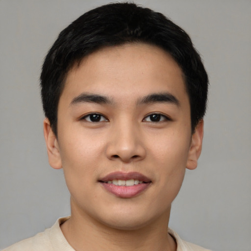 Joyful asian young-adult male with short  black hair and brown eyes