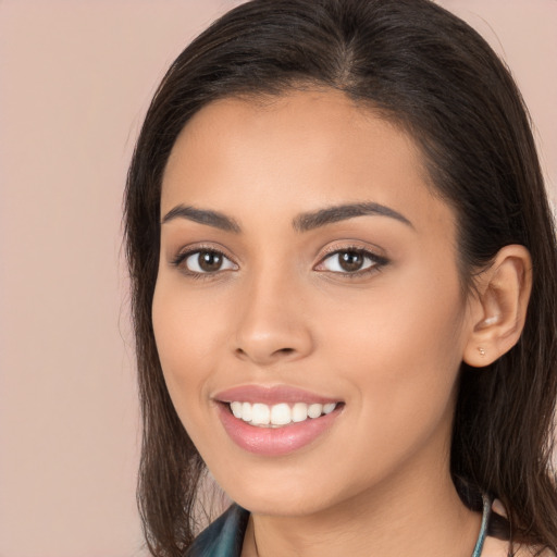 Joyful white young-adult female with long  brown hair and brown eyes