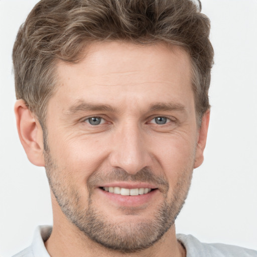 Joyful white adult male with short  brown hair and brown eyes