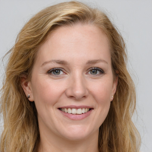 Joyful white young-adult female with long  brown hair and blue eyes