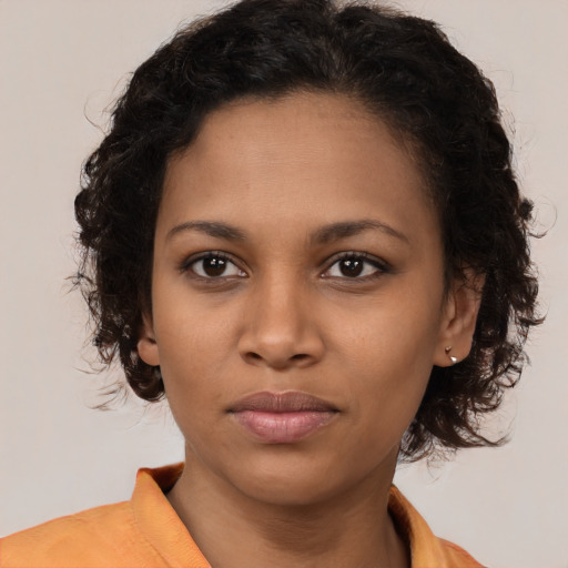Neutral black young-adult female with medium  brown hair and brown eyes