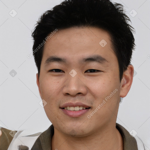 Joyful asian young-adult male with short  black hair and brown eyes