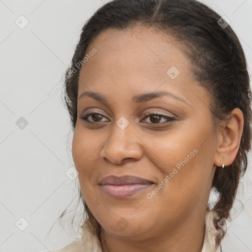 Joyful black young-adult female with long  brown hair and brown eyes