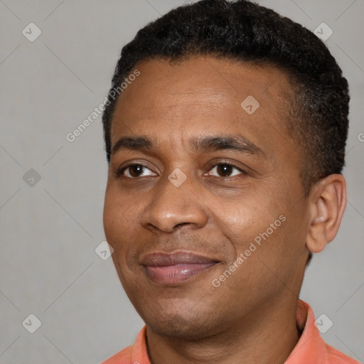 Joyful black adult male with short  black hair and brown eyes