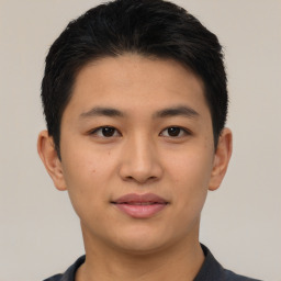 Joyful asian young-adult male with short  black hair and brown eyes