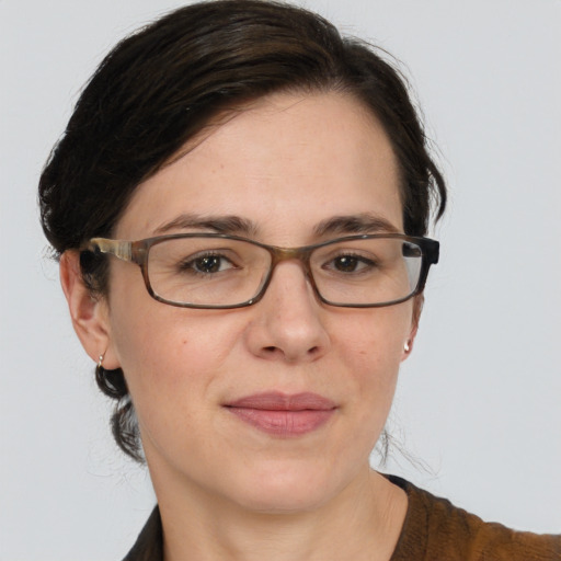 Joyful white adult female with medium  brown hair and brown eyes